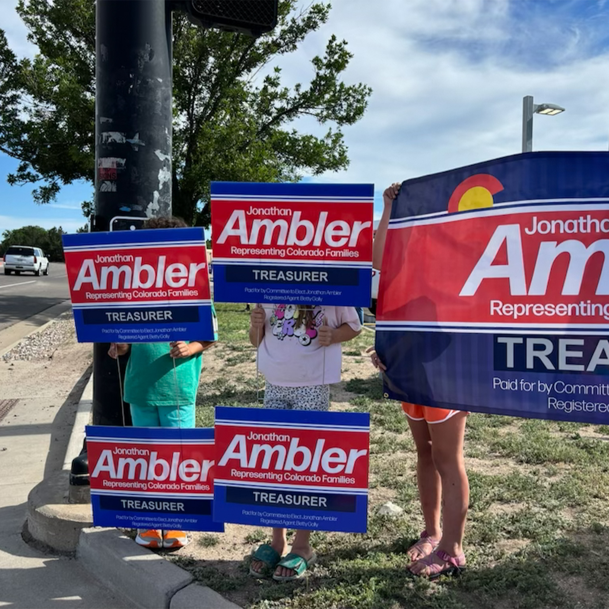 kids helping with a sign wave